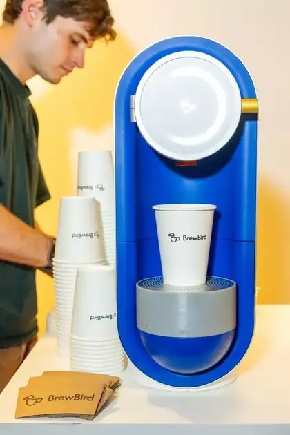 Forrest Singletary beside a BrewBird coffee brewer